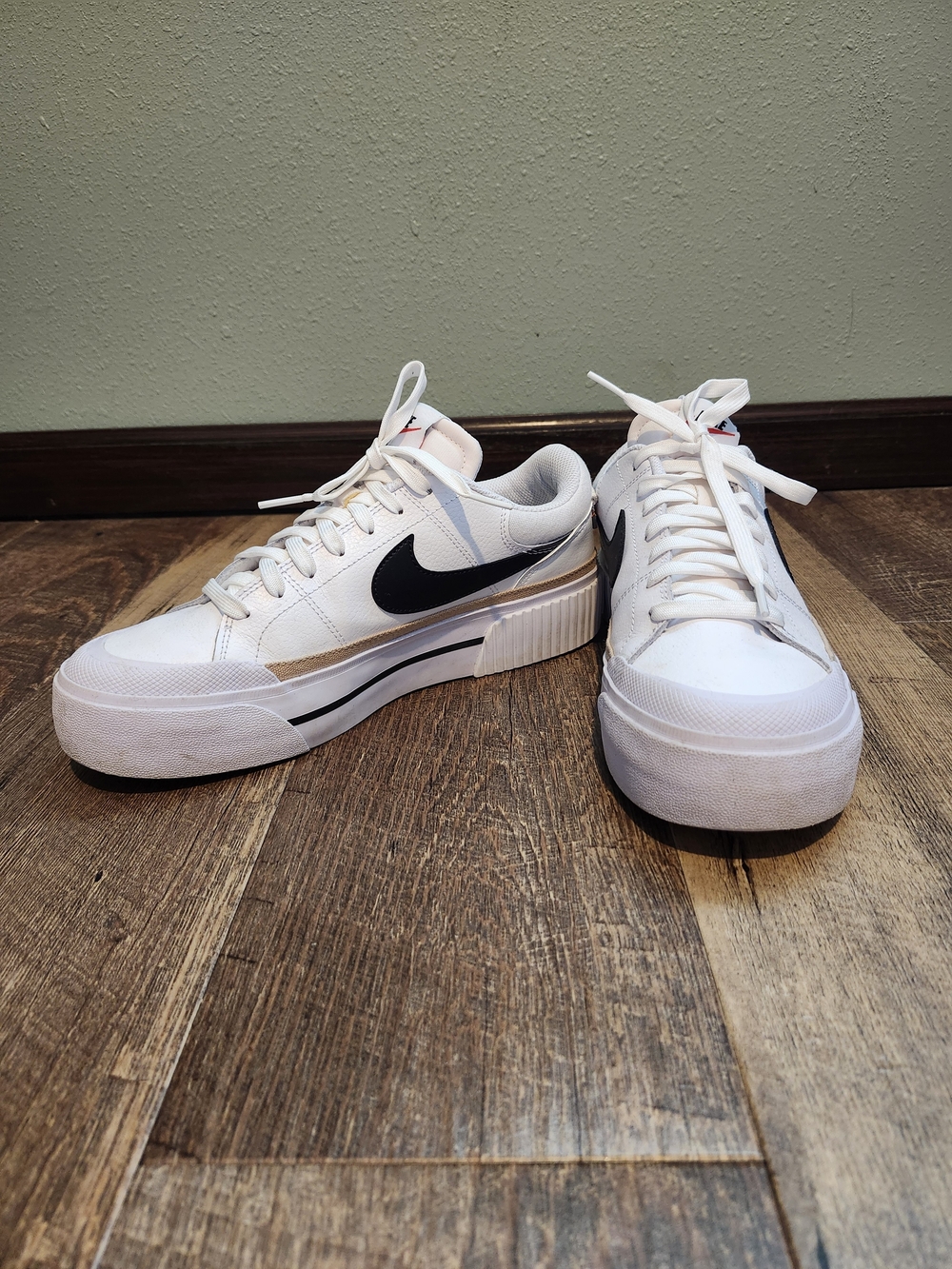 Nike Women’s White Platform Sneakers with Black Swoosh and Gold Accent